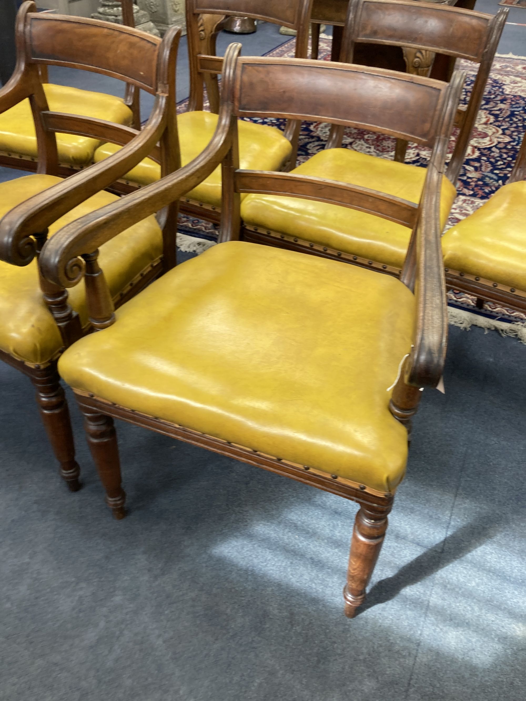 A set of six early Victorian mahogany dining chairs, two with arms